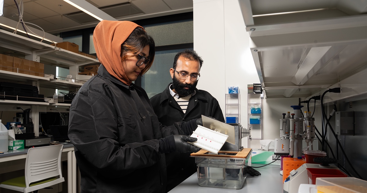 Mohit Verma in lab with grad student 
