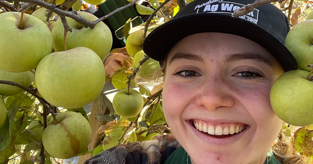 Natalie Nenneker poses with apples 