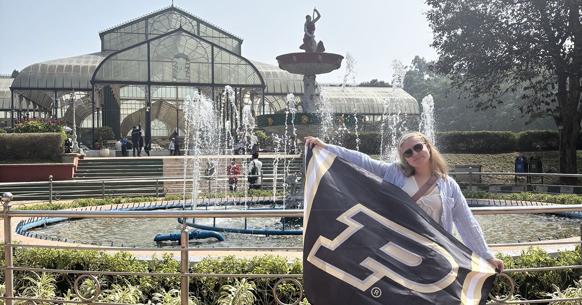 Abigail Bothwell holds Purdue flag on study ab