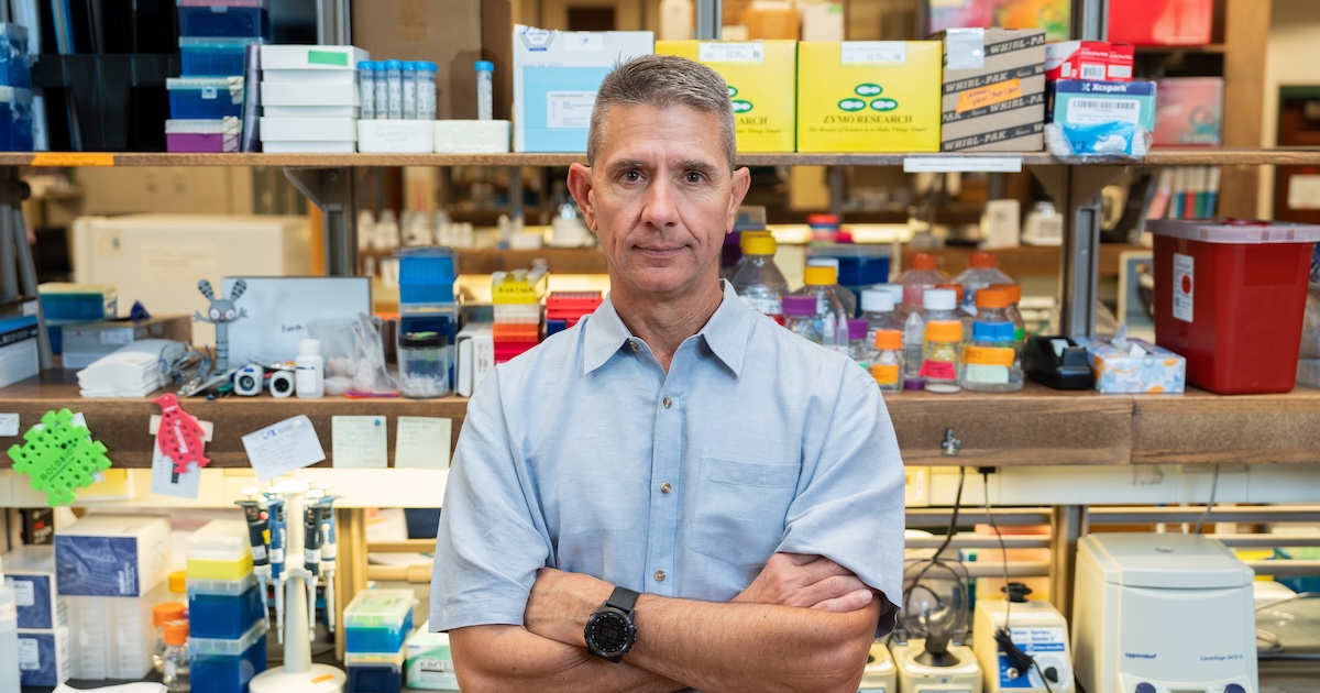 Andrew DeWoody stands in front of test equipment in his lab in West Lafayette, Ind.