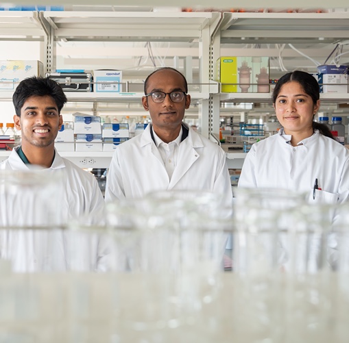 Scientist in lab with students. 