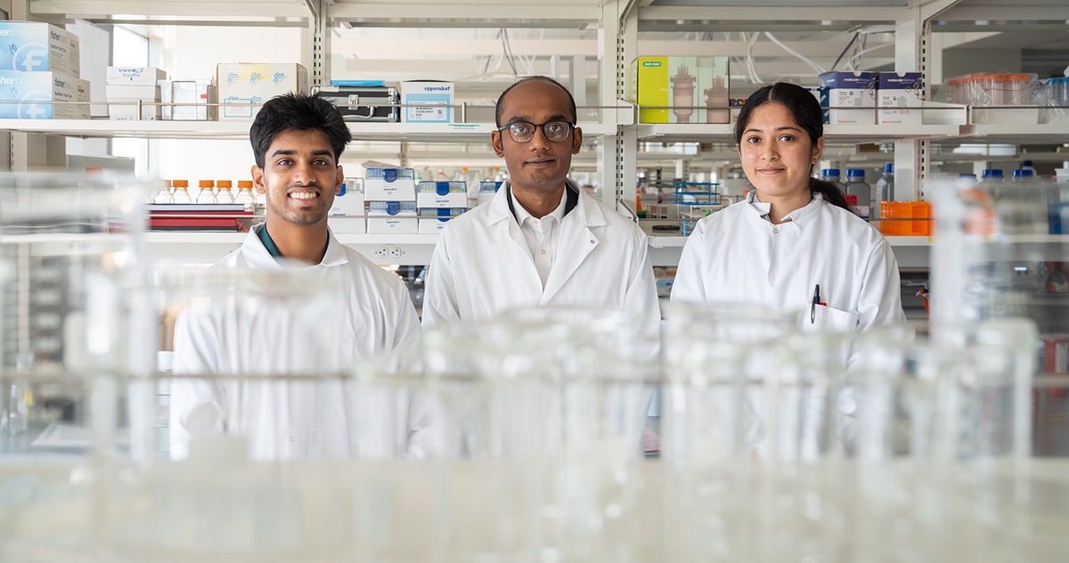 Scientist in lab with students. 
