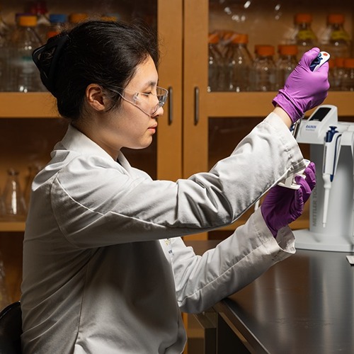 Yi-Kai Liu, W. Andy Tao, Zhoujun Luo, and Zheng Zhang stand in a row wearing white lab coats.