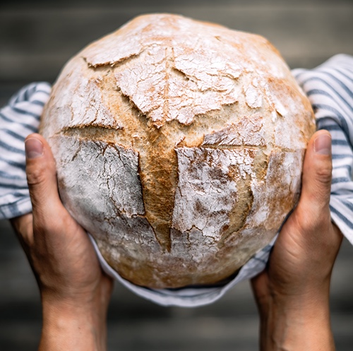 sourdough loaf being held in hands