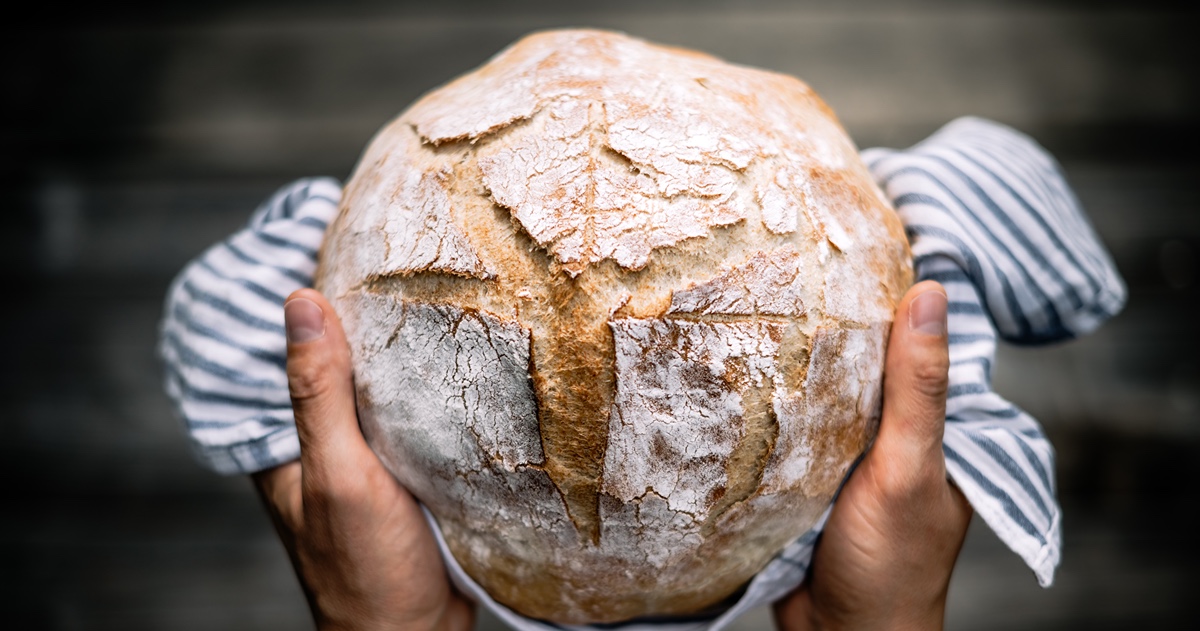 sourdough loaf being held in hands