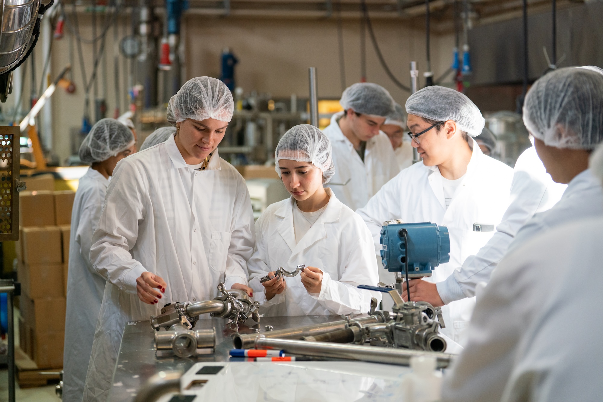 Students at the Purdue Pilot Plant examining manufacturing technology.