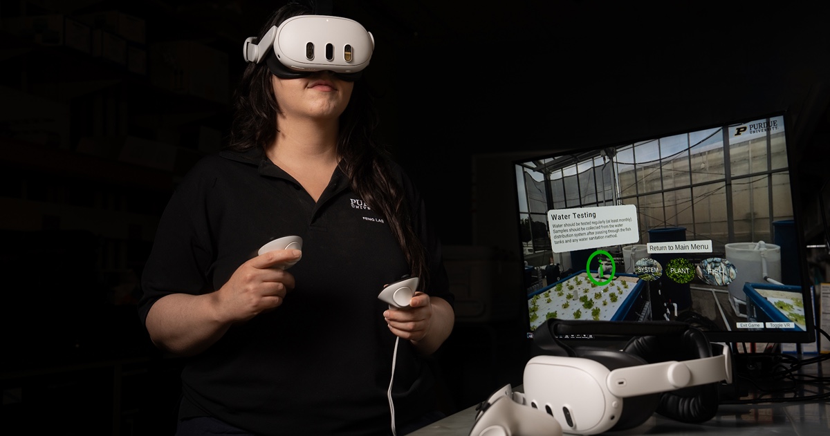 A woman wearing virtual reality glasses engages with a computer screen.
