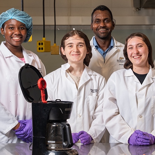 FEMI team for Java House project in lab by coffee makers they tested.