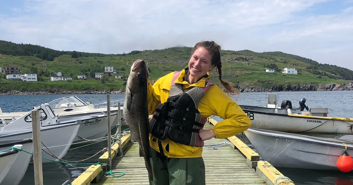 Emily Laage stands with large fish