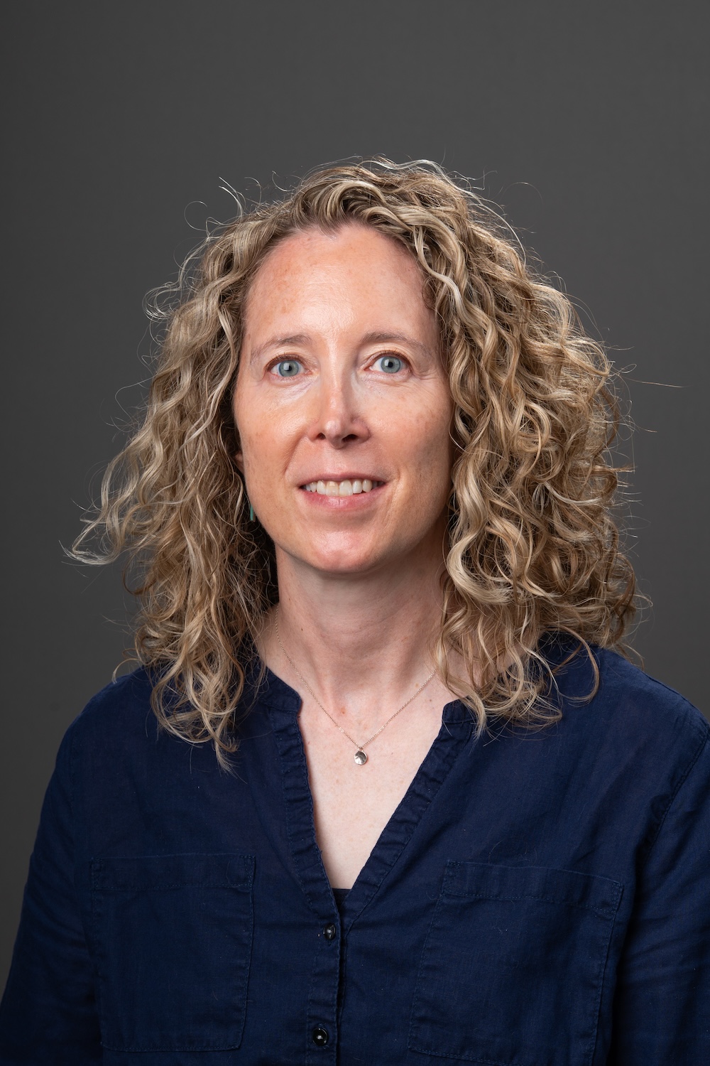 Headshot of Elizabeth Flaherty in front of grey backdrop.