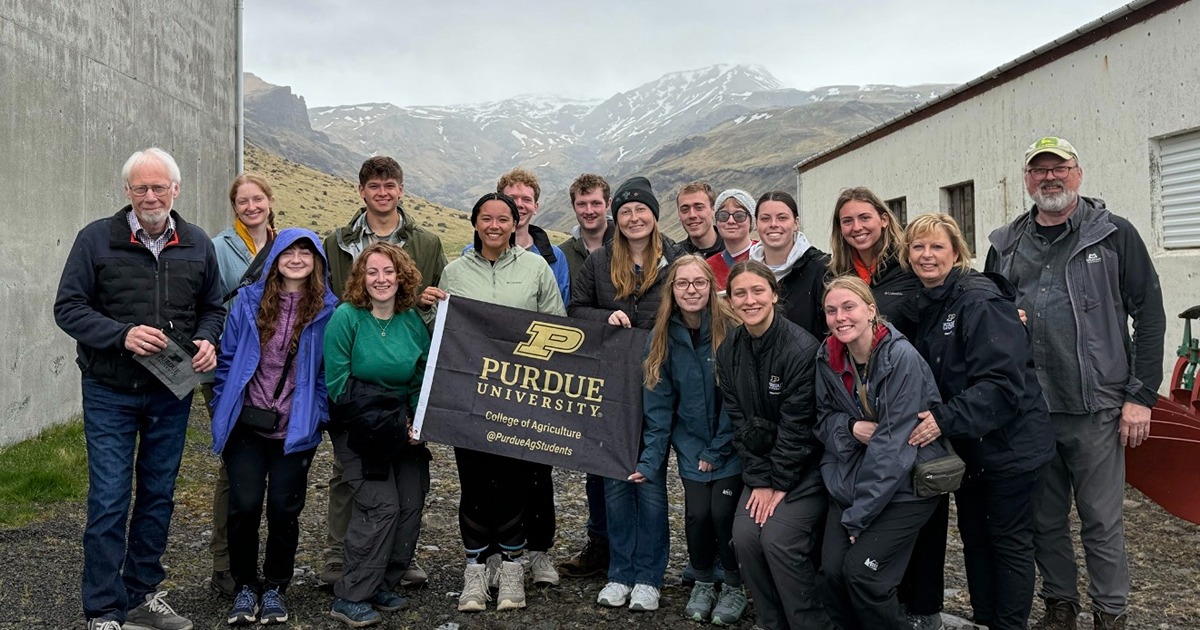 Study abroad group with Purdue Agriculture flag