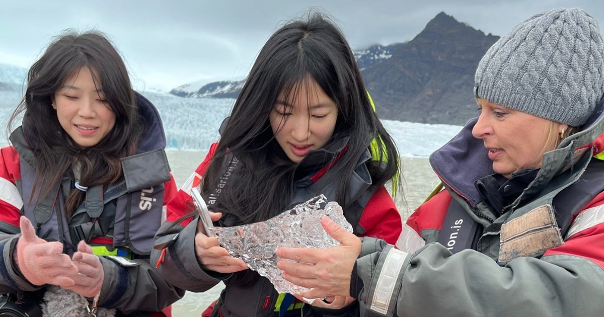 Wilson holds ice with students on boat