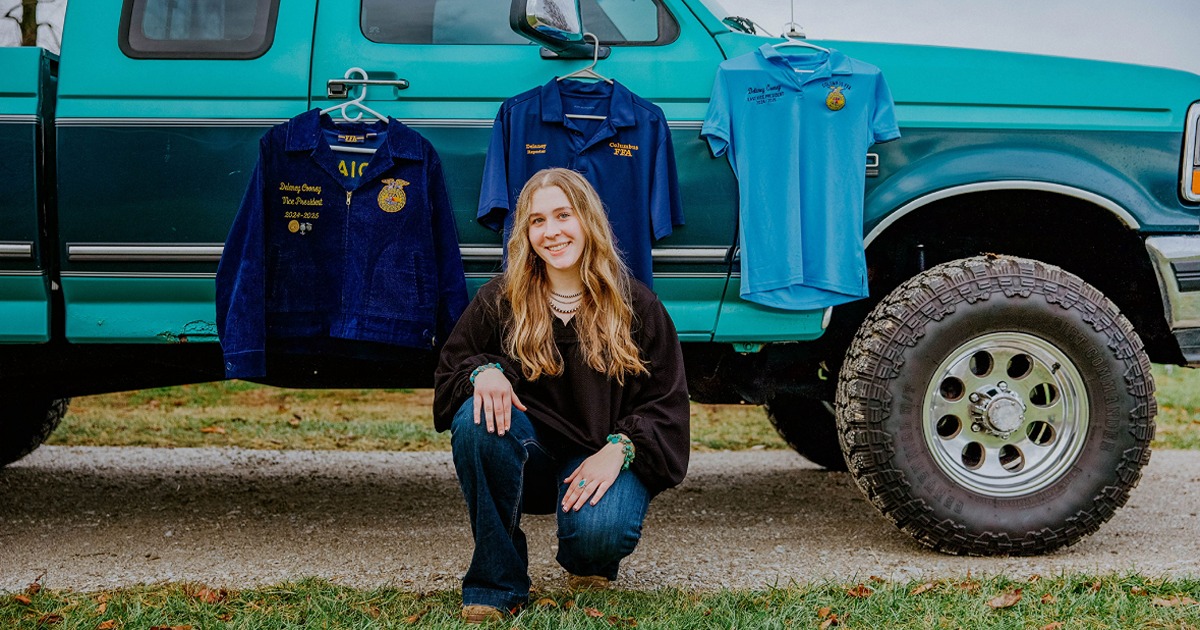 Cooney senior photo with FFA jackets and old farm truck
