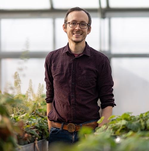 Ryan Folk in a greenhouse.