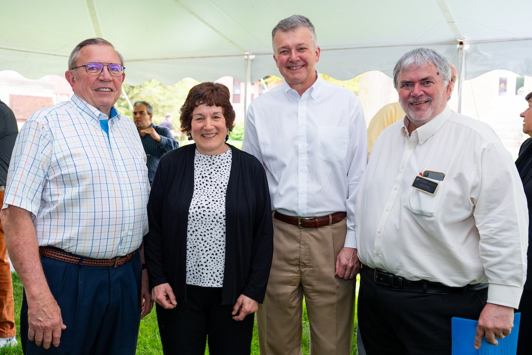 Four Purdue Ag deans standing under party tent