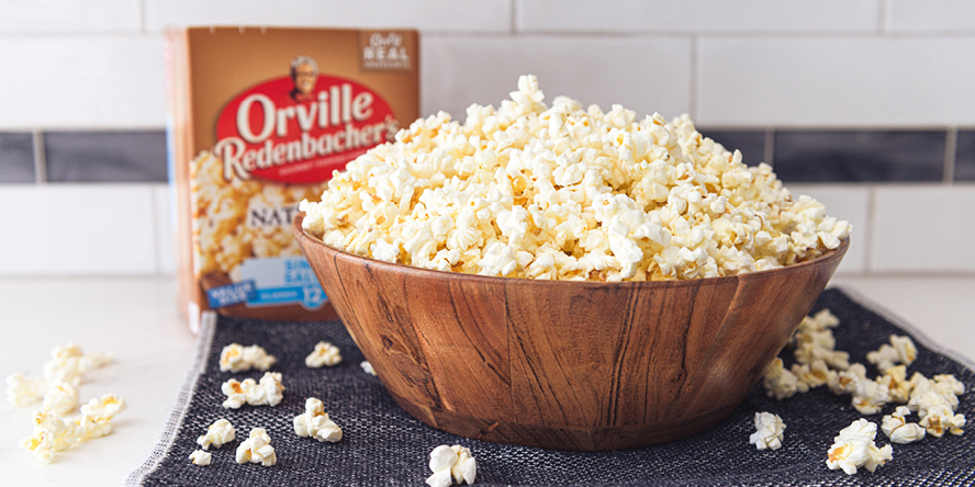 countertop with bowl and box of Orville Redenbacher popcorn