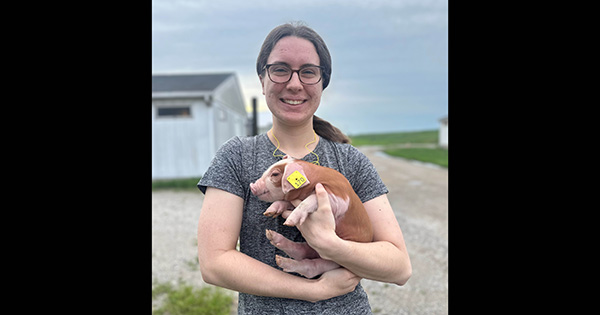 girl holding a piglet