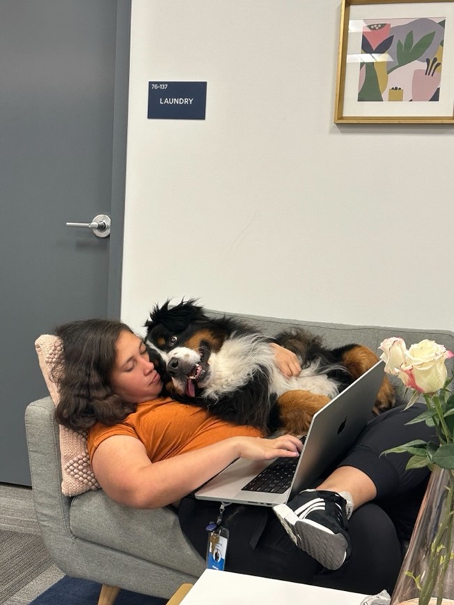 a woman laying with her dog