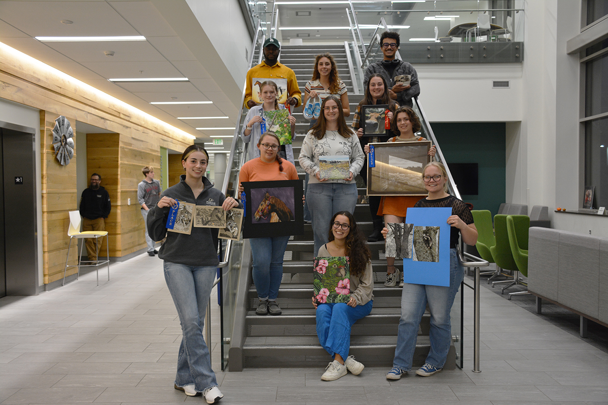 a group of people holding art pieces