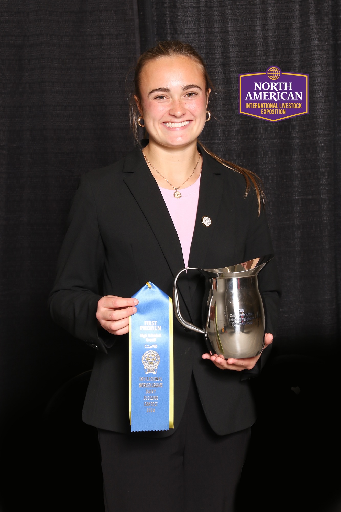 a female holding an award