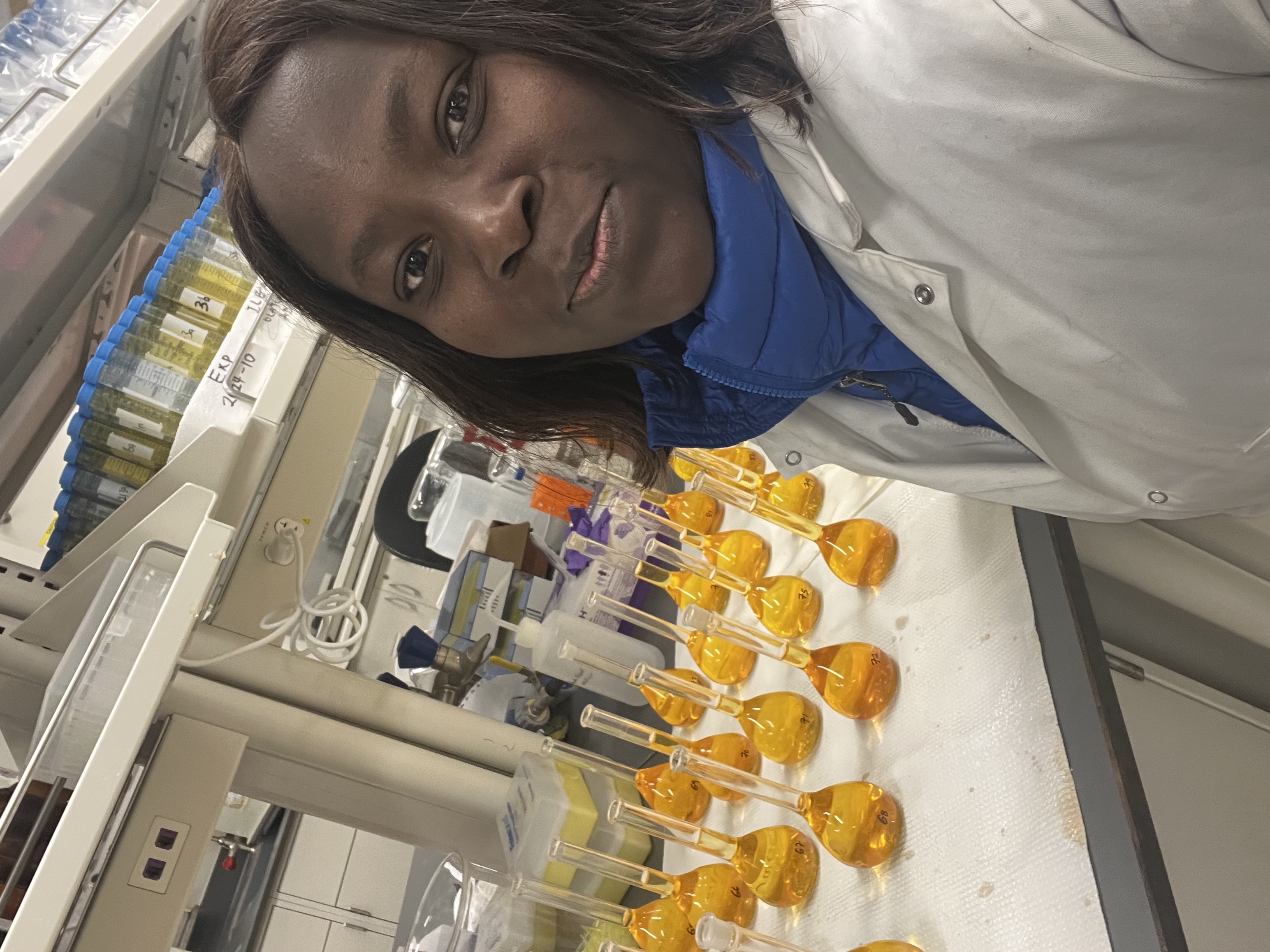 a woman in front of test tubes