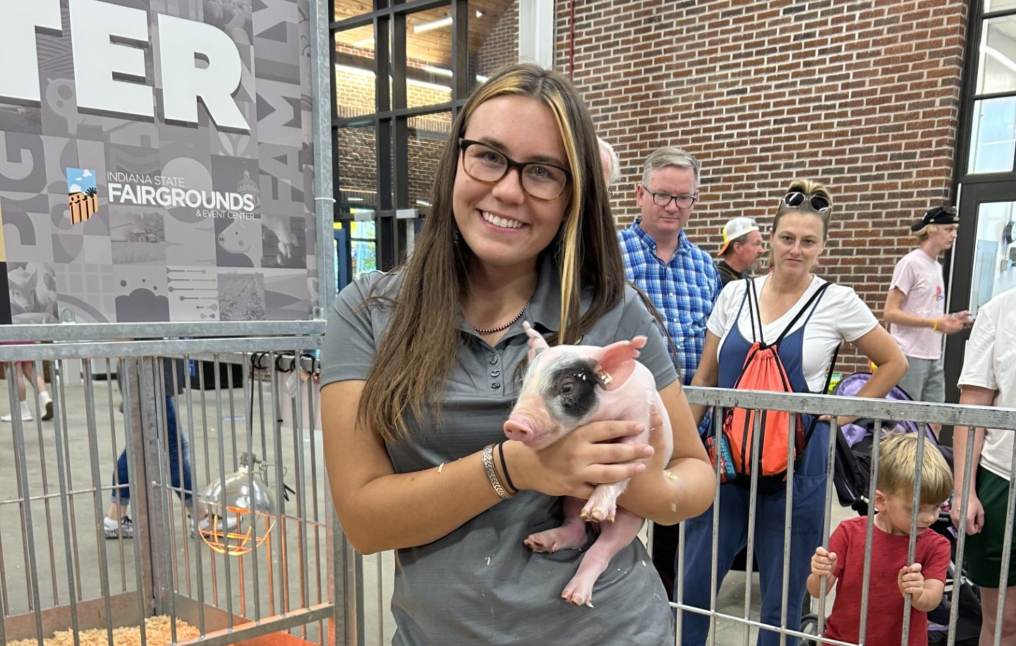 a female holding a pig