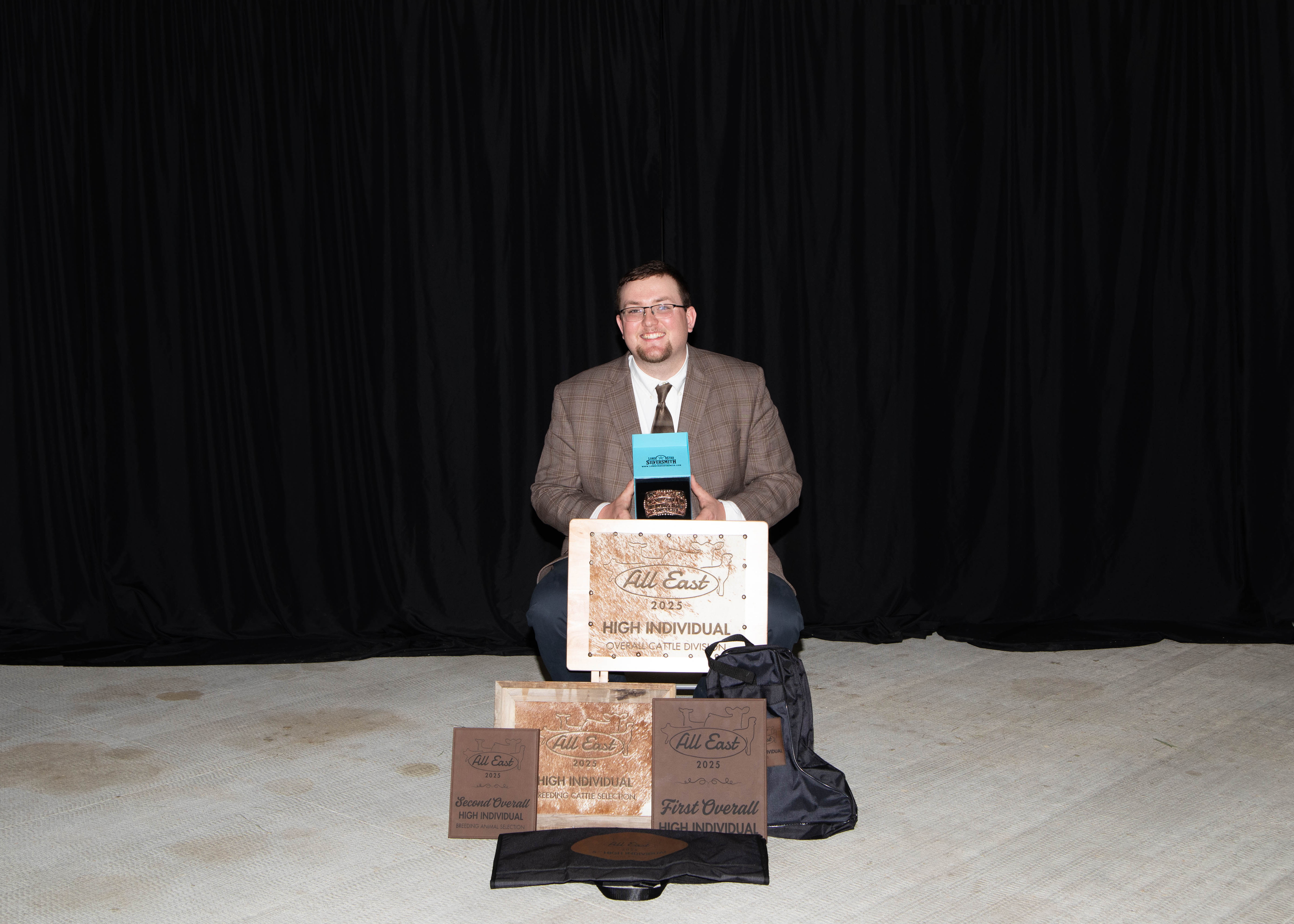 a man holding awards