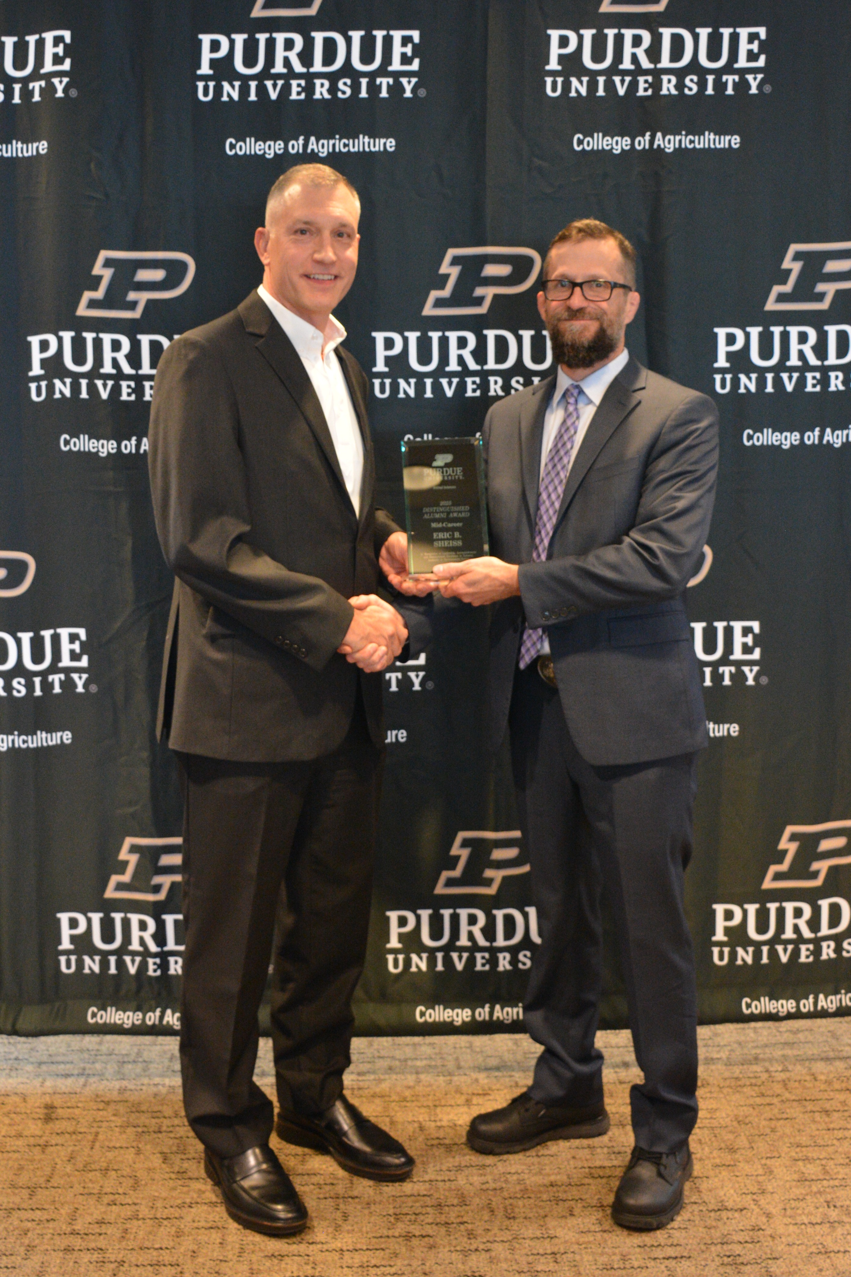 two men holding an award