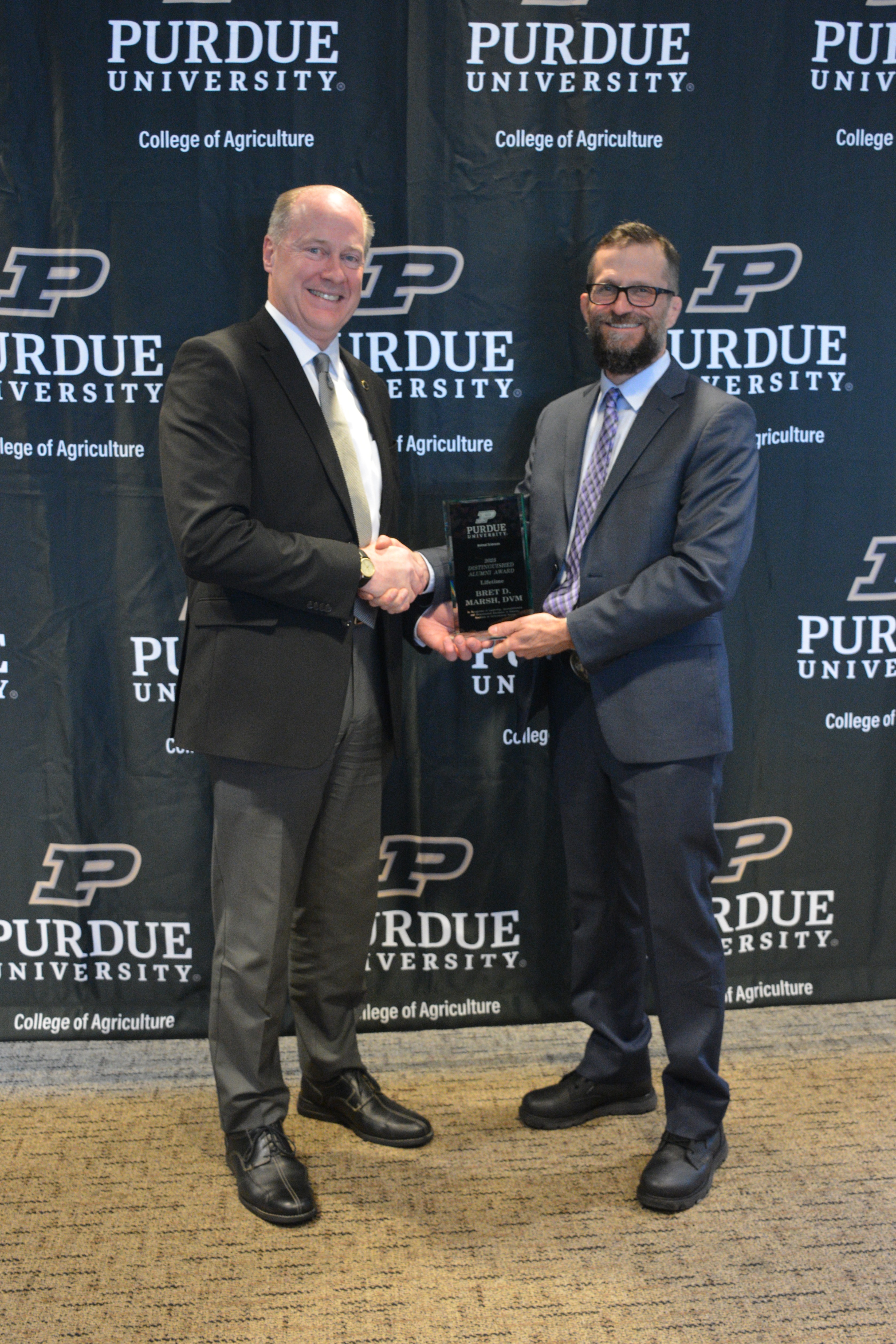 two men holding an award