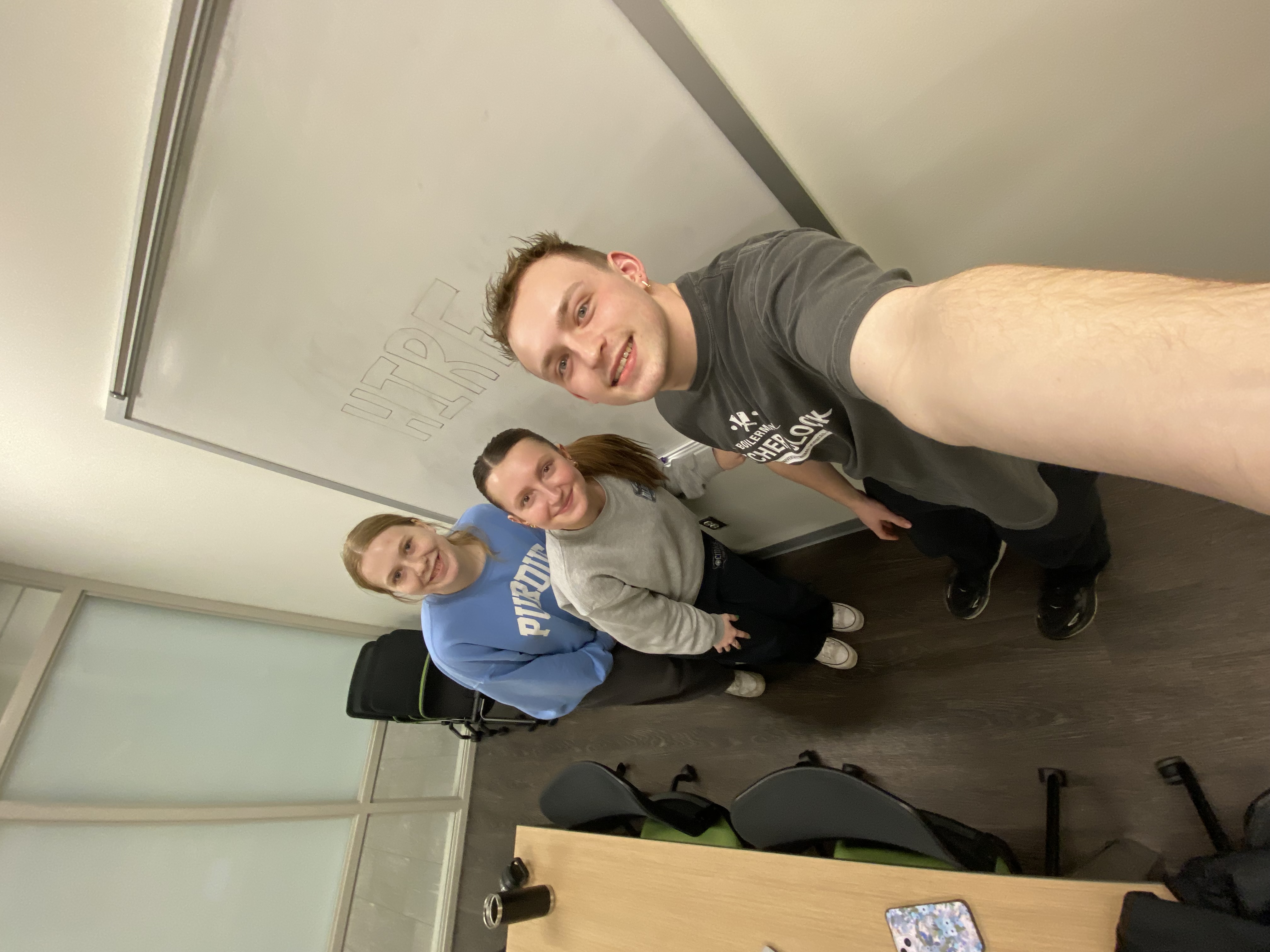 three people smiling for a selfie