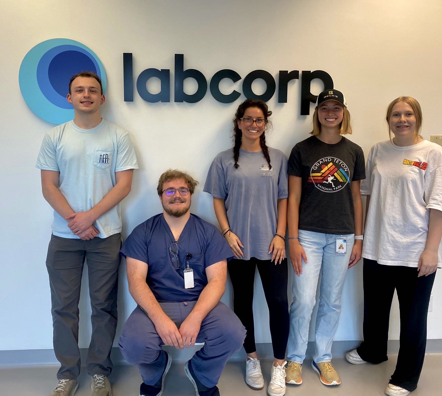 a group of five individuals in front of a Labcorp sign. From left to right: Will Eberhart, Matthew Johnson, Cassidy Hayes, Stella Houchins, Lillian Andis