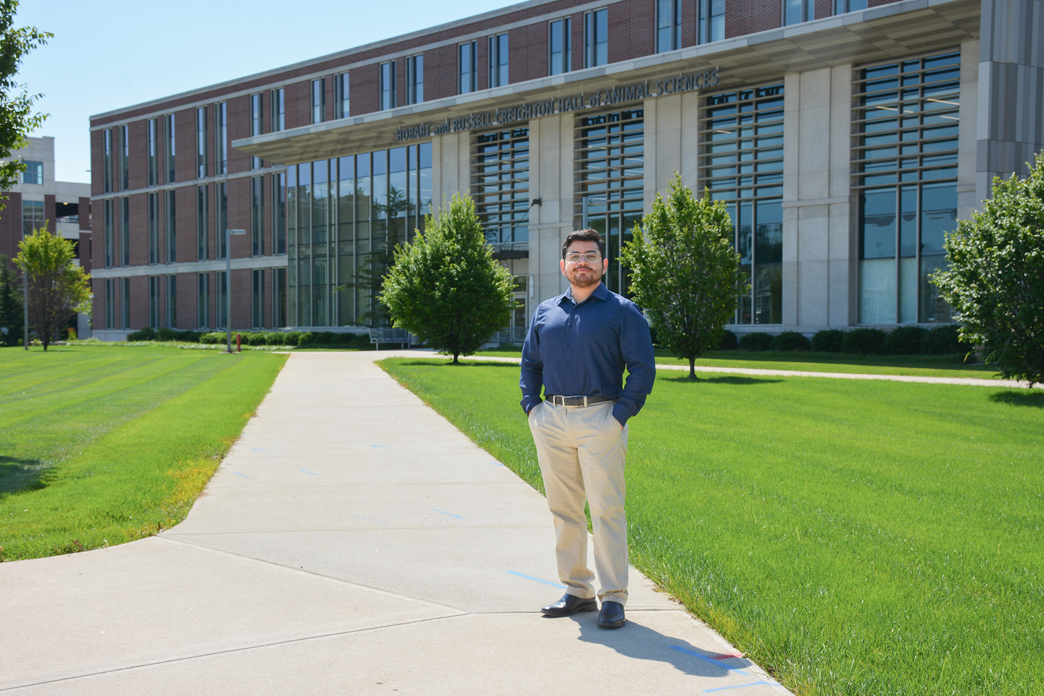 Artur Rocha stands in front of Creighton Hall.