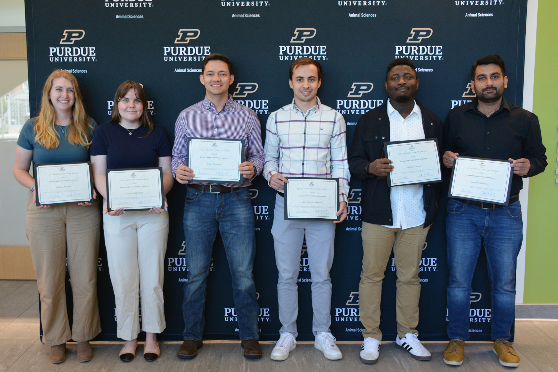 Six people hold awards certificates.