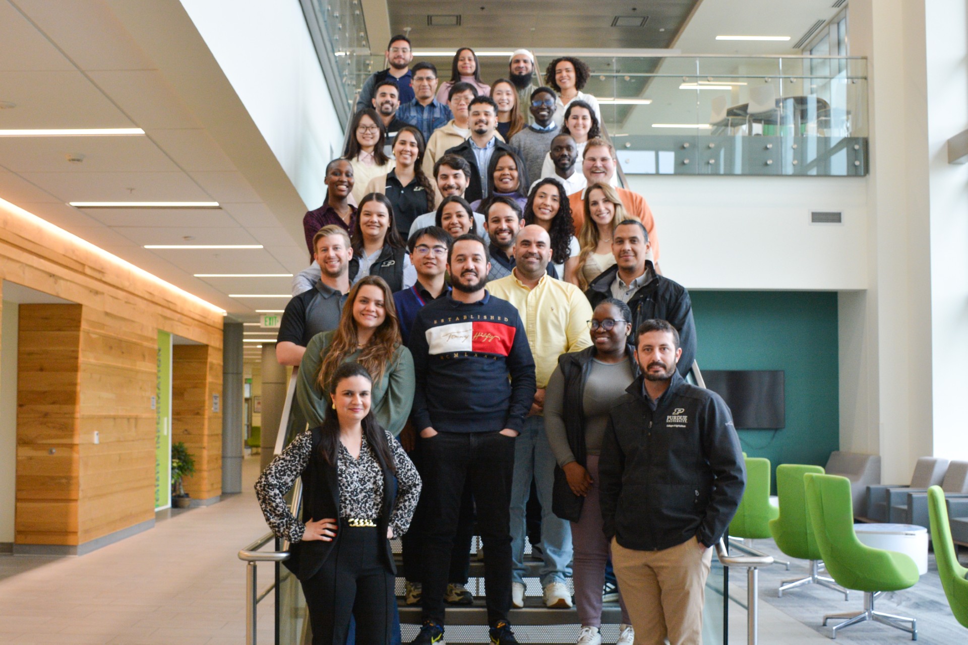 Researchers stand together on a set of stairs.
