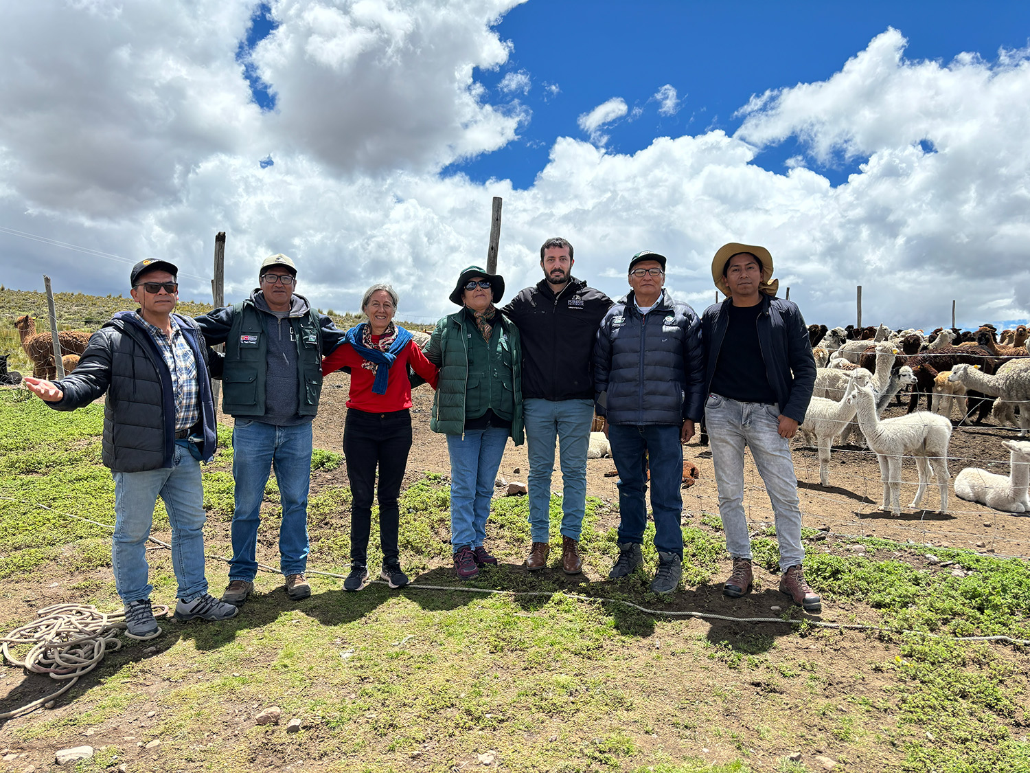 Luiz Brito stands with global collaborators in a field.
