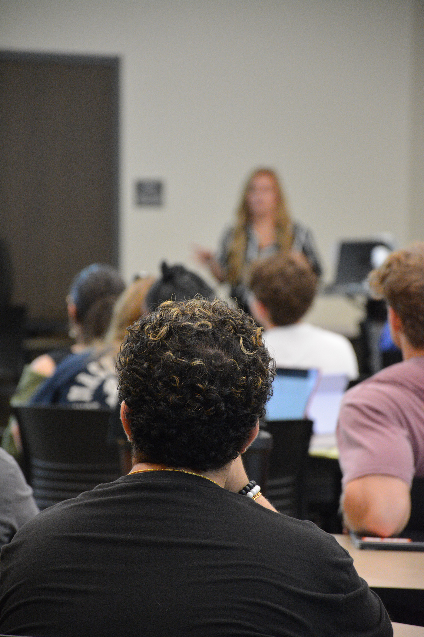 A student listens to a speaker.