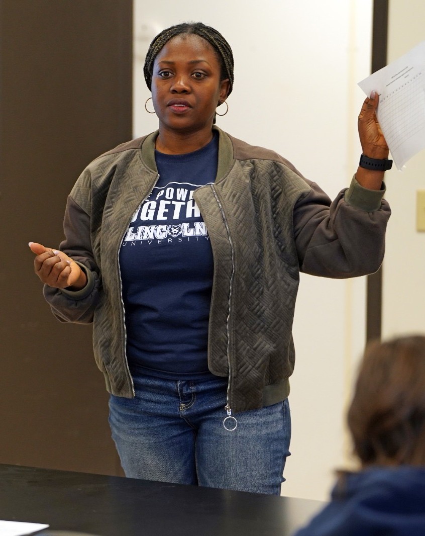 Victoria Uyanga speaks to a group of students.