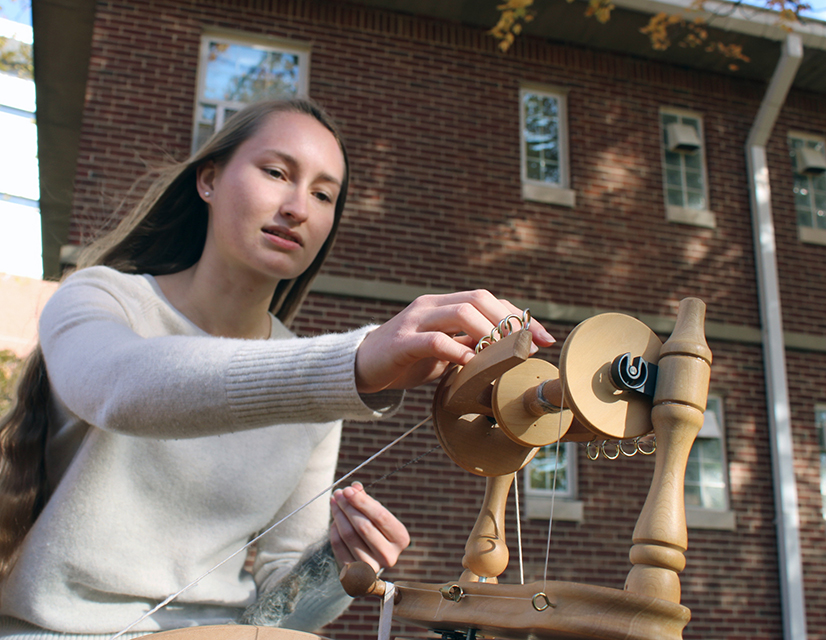 Lexi LaMar at her spinning wheel