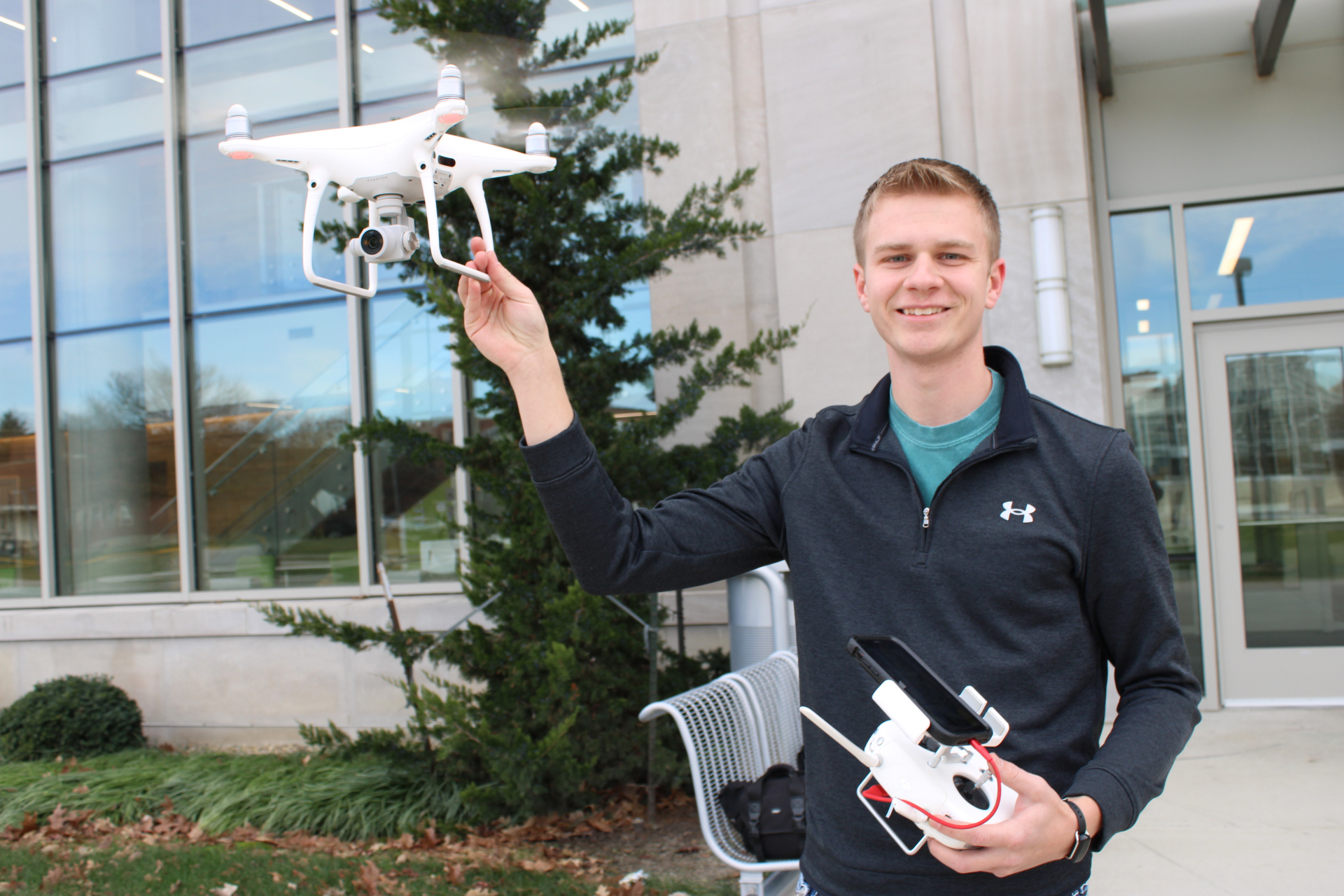 Zach Sickle holds a drone