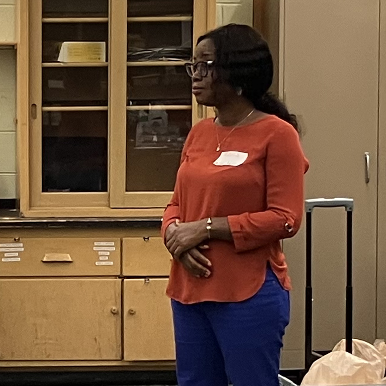 Mavis Akom, ASEC doctoral student, and Favour Ojike, ASEC master’s student, explain the composition of the Earth using an apple during the Soil and Forensic Sciences STEM 4-H Day Camp.