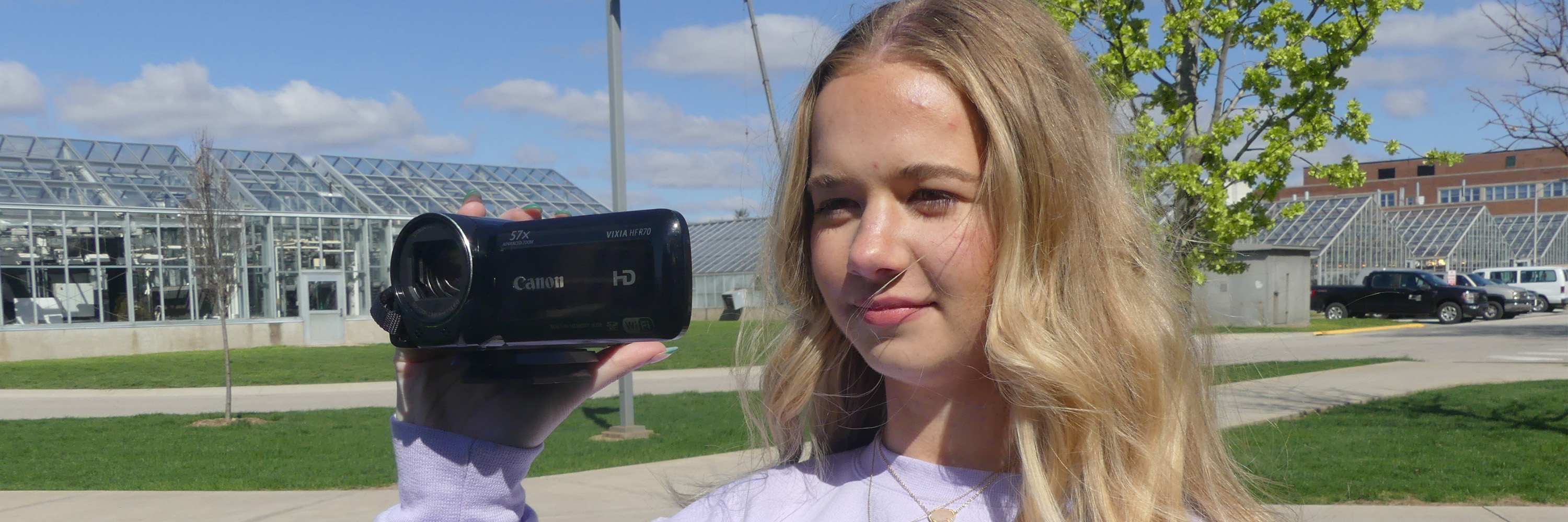 Student operating a video camera