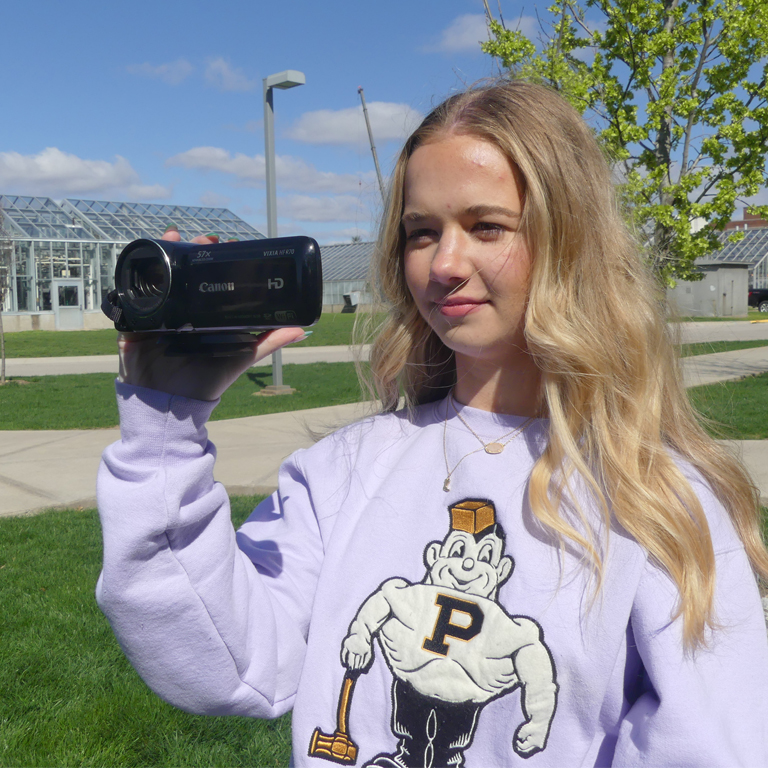 Student operating a video camera