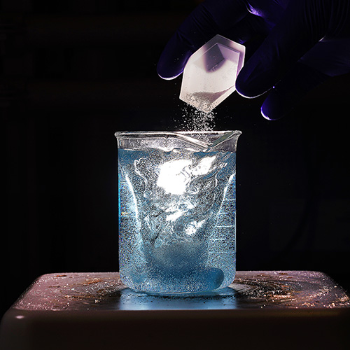 powder being poured into a beaker