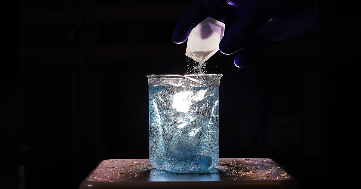 powder being poured into a beaker