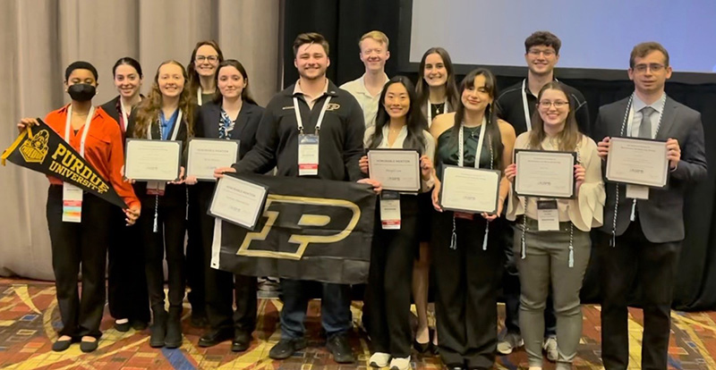 Group of Biochemistry students holding up award certificates