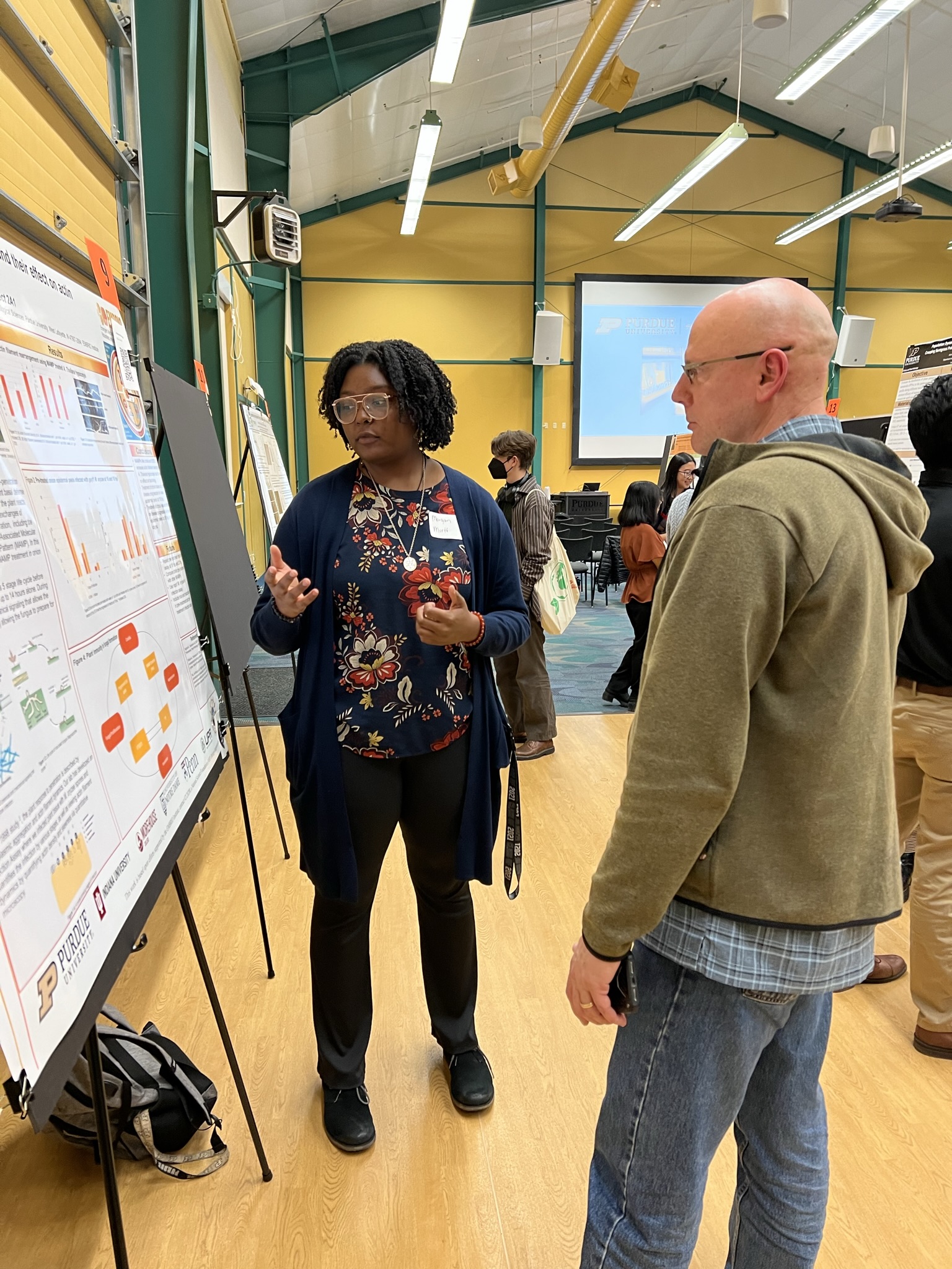 individuals looking at research poster