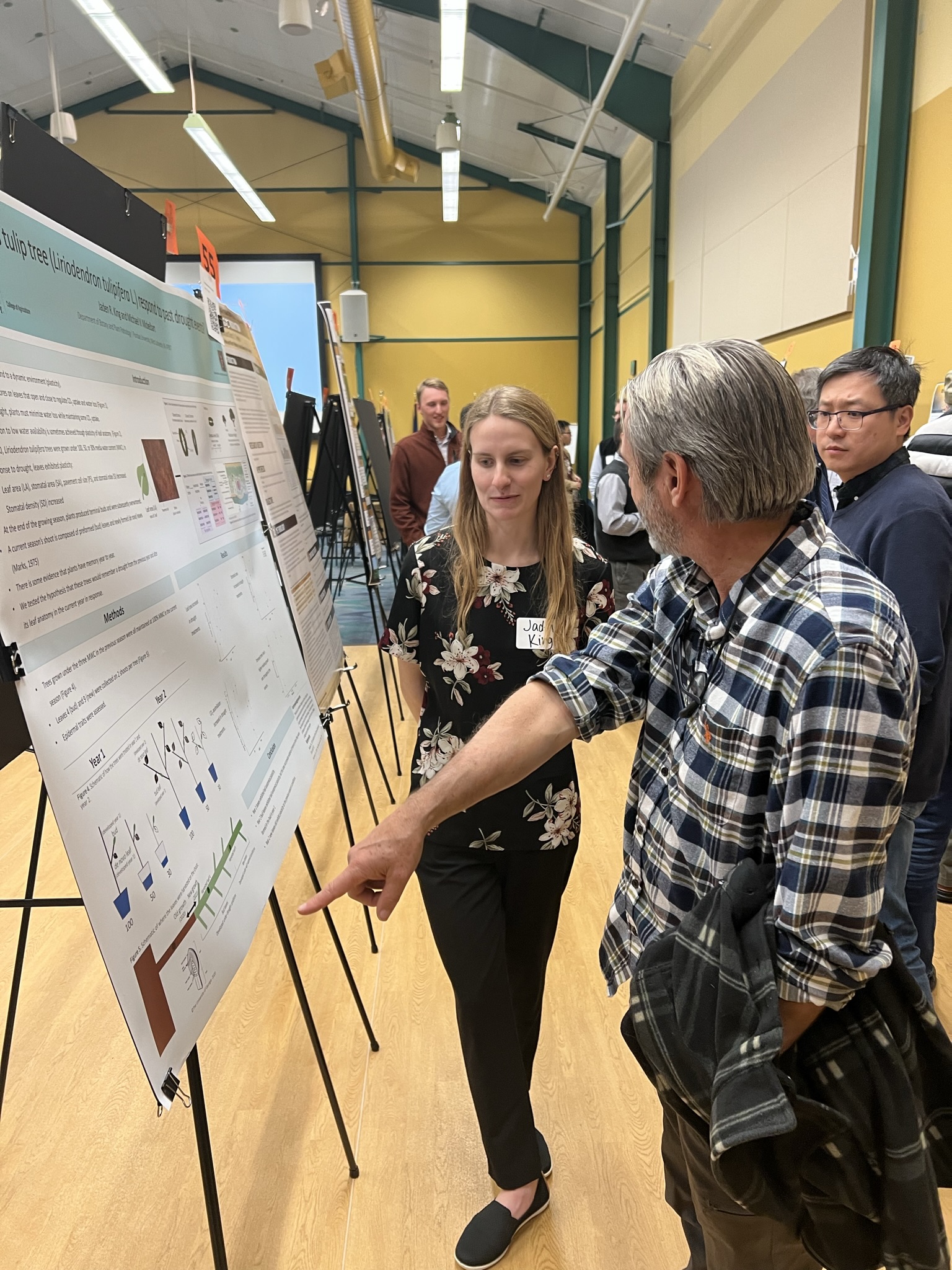 individuals looking at research poster