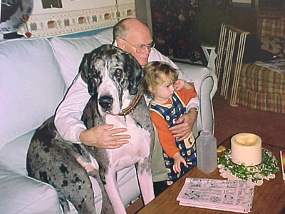 Dr. Carl Eckelman with a dog and one of his grandchildren