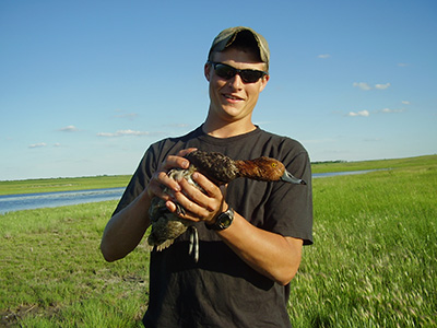 Janke with a redhead duck in North Dakota, circa 2008