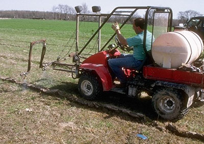 Jack Seifert sits on a four-wheeler with a sprayer in the 1990s